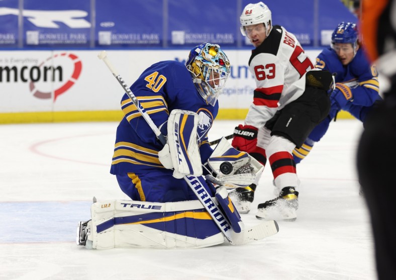 Jan 31, 2021; Buffalo, New York, USA; Buffalo Sabres goaltender Carter Hutton (40) makes a glove save during the third period against the New Jersey Devils at KeyBank Center. Mandatory Credit: Timothy T. Ludwig-USA TODAY Sports