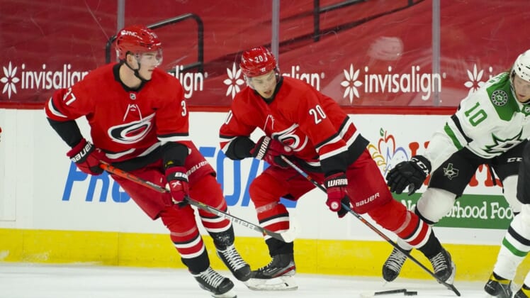 Jan 31, 2021; Raleigh, North Carolina, USA;  Carolina Hurricanes right wing Sebastian Aho (20) and right wing Andrei Svechnikov (37) skate with the puck against the Dallas Stars at PNC Arena. Mandatory Credit: James Guillory-USA TODAY Sports