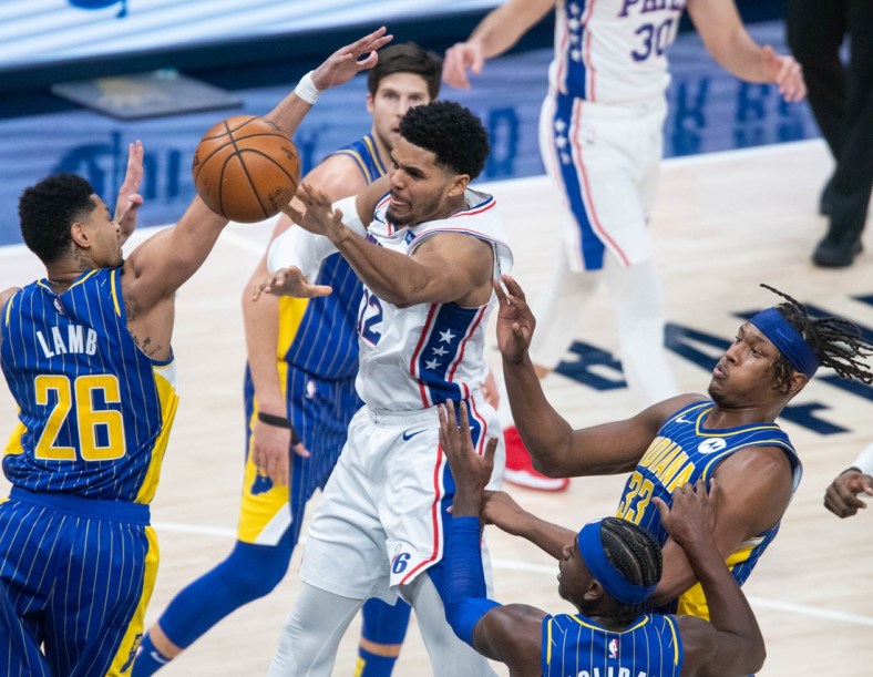 Jan 31, 2021; Indianapolis, Indiana, USA; Philadelphia 76ers forward Tobias Harris (12) passes the ball away from the Indiana Pacers defense in the fourth quarter at Bankers Life Fieldhouse. Mandatory Credit: Trevor Ruszkowski-USA TODAY Sports