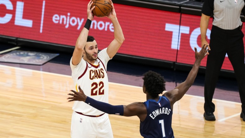 Jan 31, 2021; Minneapolis, Minnesota, USA; Cleveland Cavaliers forward Larry Nance Jr. (22) controls the ball against Minnesota Timberwolves guard Anthony Edwards (1) in the third quarter at Target Center. Mandatory Credit: David Berding-USA TODAY Sports