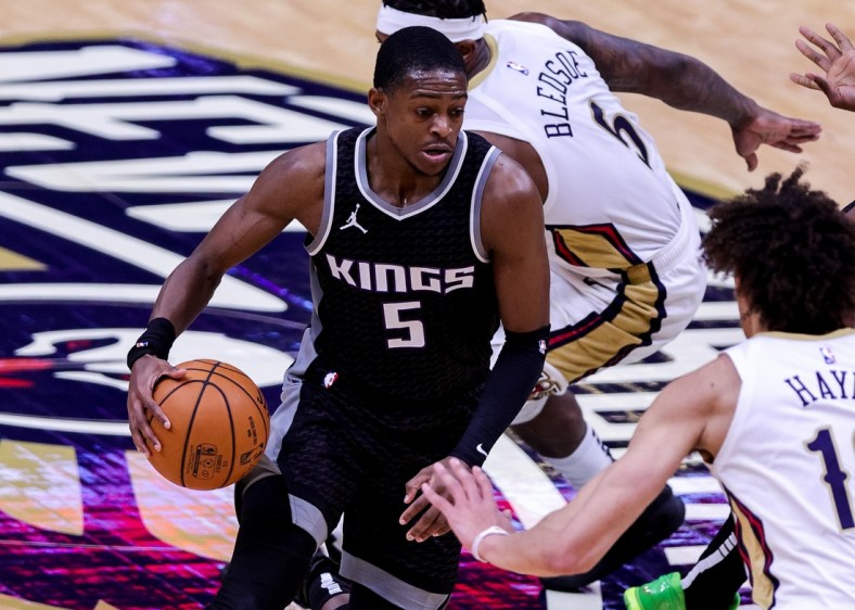 Feb 1, 2021; New Orleans, Louisiana, USA; Sacramento Kings guard De'Aaron Fox (5) dribbles against New Orleans Pelicans center Jaxson Hayes (10) during the first half at the Smoothie King Center. Mandatory Credit: Stephen Lew-USA TODAY Sports