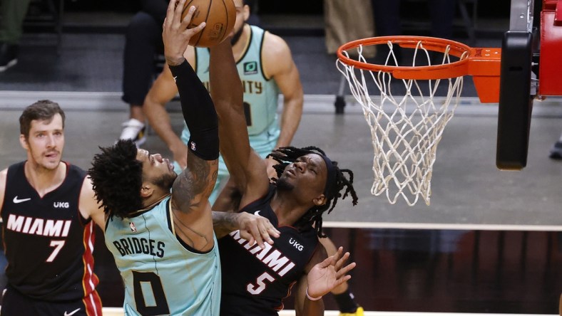 Feb 1, 2021; Miami, Florida, USA;   Miami Heat forward Precious Achiuwa (5) defends Charlotte Hornets forward Miles Bridges (0) during the first half at American Airlines Arena. Mandatory Credit: Rhona Wise-USA TODAY Sports