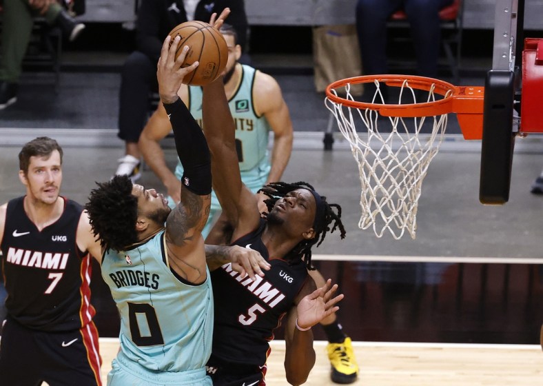 Feb 1, 2021; Miami, Florida, USA;   Miami Heat forward Precious Achiuwa (5) defends Charlotte Hornets forward Miles Bridges (0) during the first half at American Airlines Arena. Mandatory Credit: Rhona Wise-USA TODAY Sports