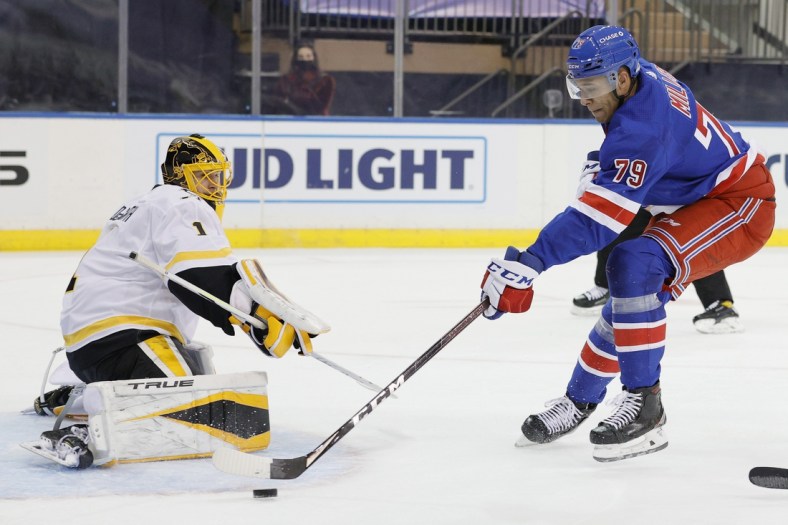 Feb 1, 2021; New York, New York, USA;  K'Andre Miller #79 of the New York Rangers takes a shot as Casey DeSmith #1 of the Pittsburgh Penguins defends during the second period at Madison Square Garden on February 01, 2021 in New York City. Mandatory Credit:  Sarah Stier/POOL PHOTOS-USA TODAY Sports
