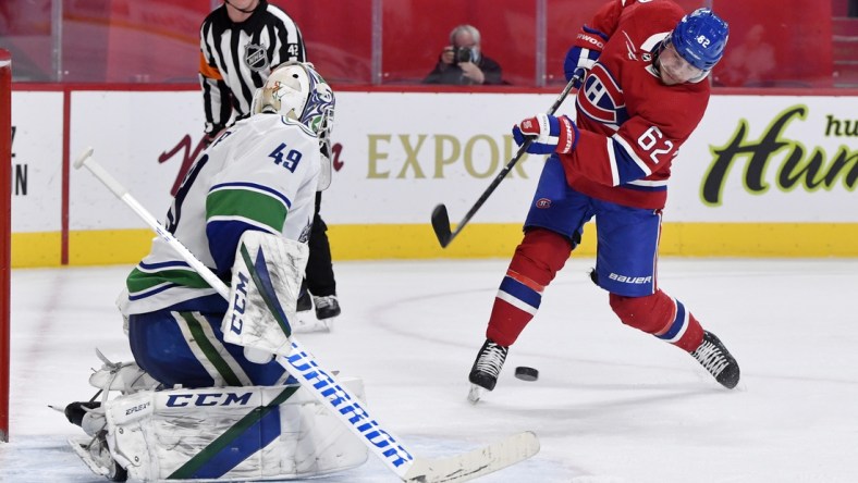 Feb 1, 2021; Montreal, Quebec, CAN; Montreal Canadiens forward Artturi Lehkonen (62) takes a shot on Vancouver Canucks goalie Braden Holtby (49) during the second period at the Bell Centre. Mandatory Credit: Eric Bolte-USA TODAY Sports