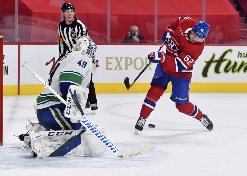 Feb 1, 2021; Montreal, Quebec, CAN; Montreal Canadiens forward Artturi Lehkonen (62) takes a shot on Vancouver Canucks goalie Braden Holtby (49) during the second period at the Bell Centre. Mandatory Credit: Eric Bolte-USA TODAY Sports