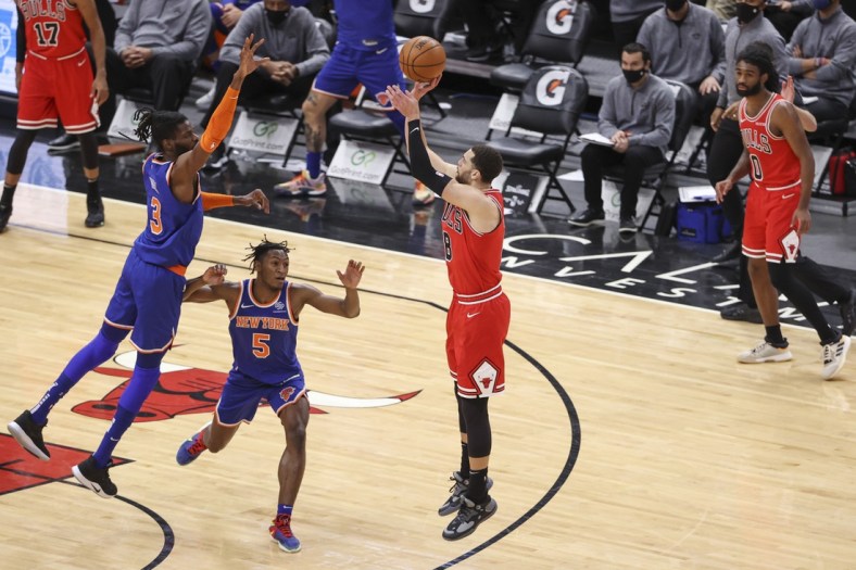 Feb 1, 2021; Chicago, Illinois, USA; Chicago Bulls guard Zach LaVine (8) shoots and scores a three-pointer against the New York Knicks during the second half of an NBA game at United Center. Mandatory Credit: Kamil Krzaczynski-USA TODAY Sports