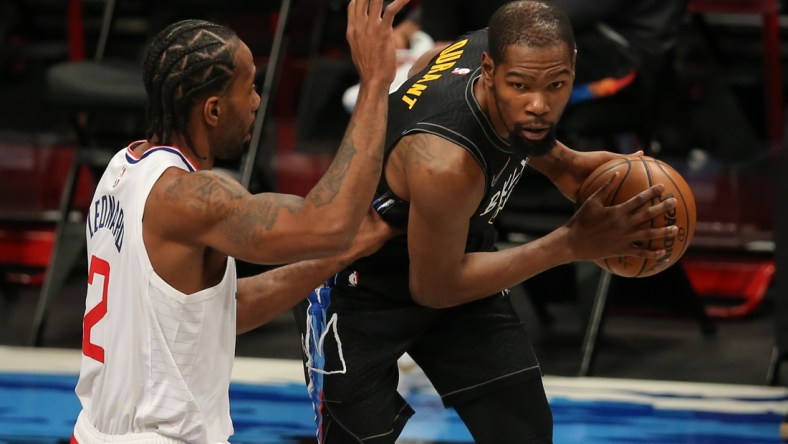 Feb 2, 2021; Brooklyn, New York, USA; Brooklyn Nets power forward Kevin Durant (7) controls the ball against Los Angeles Clippers small forward Kawhi Leonard (2) during the first quarter at Barclays Center. Mandatory Credit: Brad Penner-USA TODAY Sports