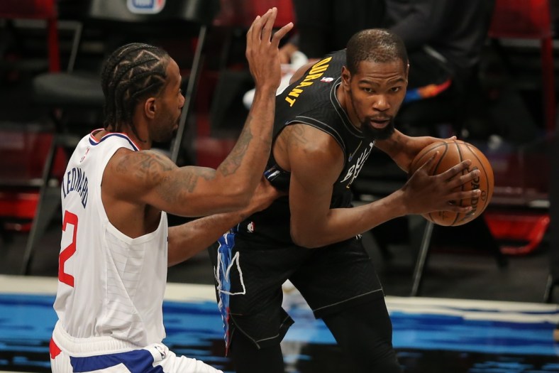 Feb 2, 2021; Brooklyn, New York, USA; Brooklyn Nets power forward Kevin Durant (7) controls the ball against Los Angeles Clippers small forward Kawhi Leonard (2) during the first quarter at Barclays Center. Mandatory Credit: Brad Penner-USA TODAY Sports