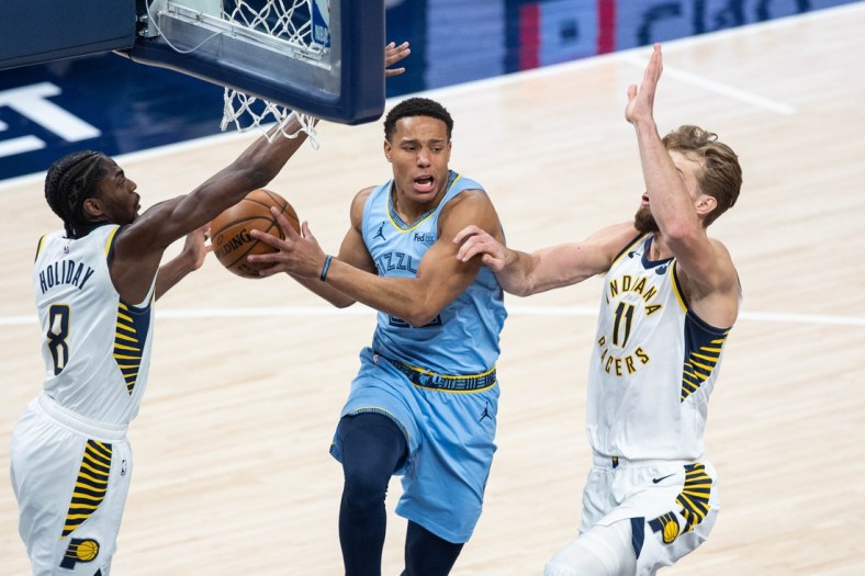 Feb 2, 2021; Indianapolis, Indiana, USA; Memphis Grizzlies guard Desmond Bane (C) goes up to shoot the ball as Indiana Pacers guard Justin Holiday (8) and forward Domantas Sabonis (11) defend in the first quarter at Bankers Life Fieldhouse. Mandatory Credit: Trevor Ruszkowski-USA TODAY Sports