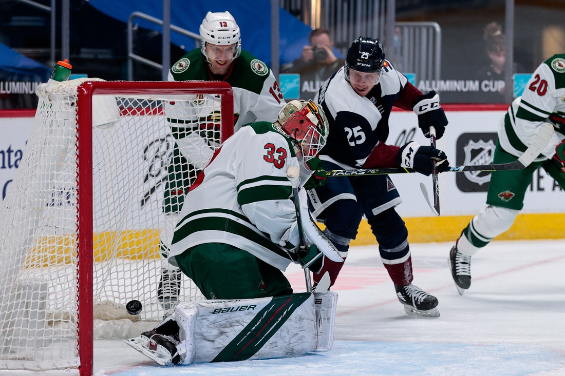 Feb 2, 2021; Denver, Colorado, USA; Colorado Avalanche right wing Logan O'Connor (25) scores past Minnesota Wild goaltender Cam Talbot (33) as center Nick Bonino (13) defends in the first period at Ball Arena. Mandatory Credit: Isaiah J. Downing-USA TODAY Sports