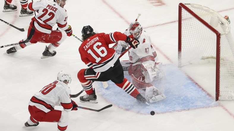 Feb 2, 2021; Chicago, Illinois, USA; Carolina Hurricanes goaltender James Reimer (47) defends against Chicago Blackhawks defenseman Nikita Zadorov (16) during the second period at United Center. Mandatory Credit: Kamil Krzaczynski-USA TODAY Sports