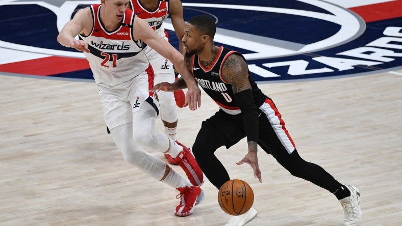 Feb 2, 2021; Washington, District of Columbia, USA; Portland Trail Blazers guard Damian Lillard (0) dribbles as Washington Wizards center Moritz Wagner (21) defends during the third quarter at Capital One Arena. Mandatory Credit: Brad Mills-USA TODAY Sports