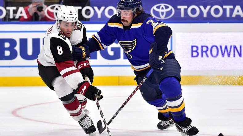 Feb 2, 2021; St. Louis, Missouri, USA;  Arizona Coyotes center Nick Schmaltz (8) handles the puck as St. Louis Blues defenseman Justin Faulk (72) defends during the second period at Enterprise Center. Mandatory Credit: Jeff Curry-USA TODAY Sports