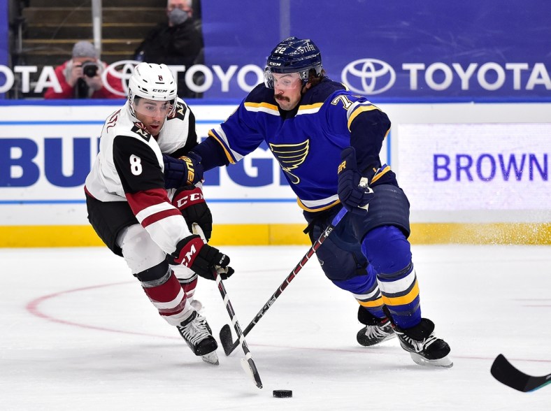 Feb 2, 2021; St. Louis, Missouri, USA;  Arizona Coyotes center Nick Schmaltz (8) handles the puck as St. Louis Blues defenseman Justin Faulk (72) defends during the second period at Enterprise Center. Mandatory Credit: Jeff Curry-USA TODAY Sports