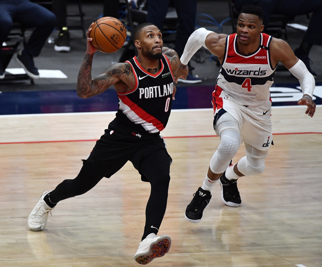 Feb 2, 2021; Washington, District of Columbia, USA; Portland Trail Blazers guard Damian Lillard (0) drives as Washington Wizards guard Russell Westbrook (4) chases during the fourth quarter at Capital One Arena. Mandatory Credit: Brad Mills-USA TODAY Sports