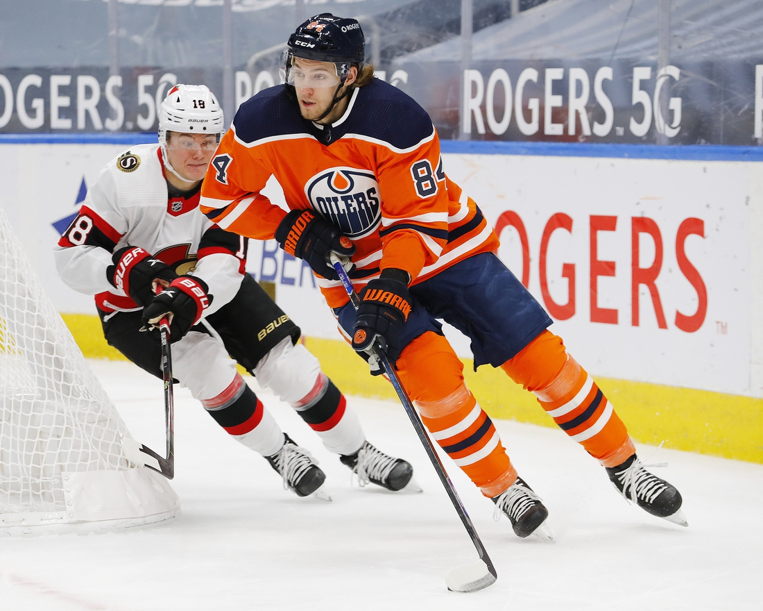 Feb 2, 2021; Edmonton, Alberta, CAN; Ottawa Senators forward Tim Stuetzle (18) chases Edmonton Oilers defensemen William Lagesson (84) during the second period at Rogers Place. Mandatory Credit: Perry Nelson-USA TODAY Sports