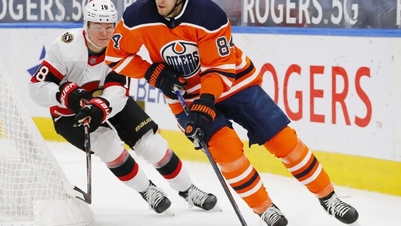 Feb 2, 2021; Edmonton, Alberta, CAN; Ottawa Senators forward Tim Stuetzle (18) chases Edmonton Oilers defensemen William Lagesson (84) during the second period at Rogers Place. Mandatory Credit: Perry Nelson-USA TODAY Sports