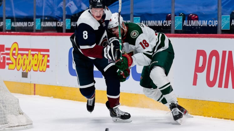 Feb 2, 2021; Denver, Colorado, USA; Colorado Avalanche defenseman Cale Makar (8) and Minnesota Wild left wing Jordan Greenway (18) battle for the puck in the third period at Ball Arena. Mandatory Credit: Isaiah J. Downing-USA TODAY Sports