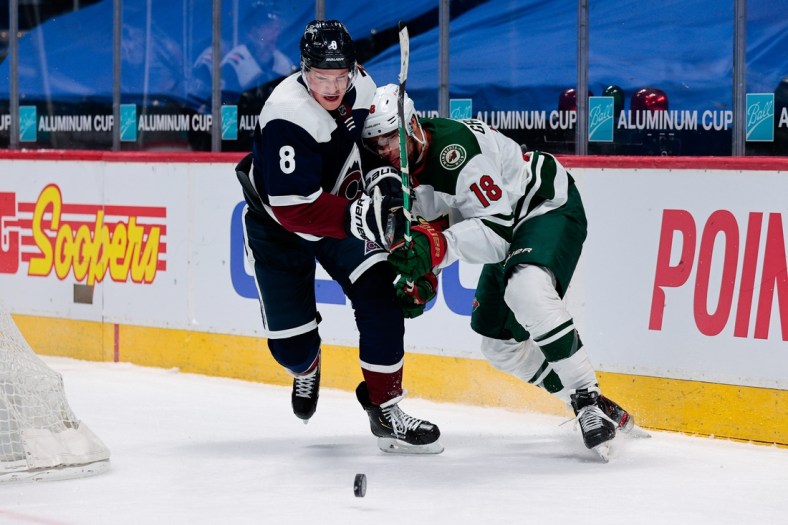 Feb 2, 2021; Denver, Colorado, USA; Colorado Avalanche defenseman Cale Makar (8) and Minnesota Wild left wing Jordan Greenway (18) battle for the puck in the third period at Ball Arena. Mandatory Credit: Isaiah J. Downing-USA TODAY Sports