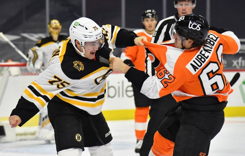Feb 5, 2021; Philadelphia, Pennsylvania, USA; Boston Bruins defenseman Connor Clifton (75) and Philadelphia Flyers right wing Nicolas Aube-Kubel (62) exchange punches during the first period at Wells Fargo Center. Mandatory Credit: Eric Hartline-USA TODAY Sports