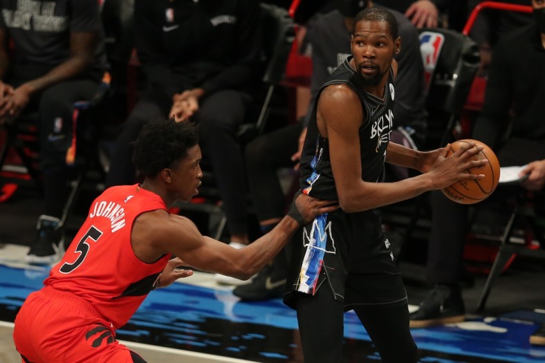 Feb 5, 2021; Brooklyn, New York, USA; Brooklyn Nets power forward Kevin Durant (7) controls the ball against Toronto Raptors small forward Stanley Johnson (5) during the second quarter at Barclays Center. Mandatory Credit: Brad Penner-USA TODAY Sports