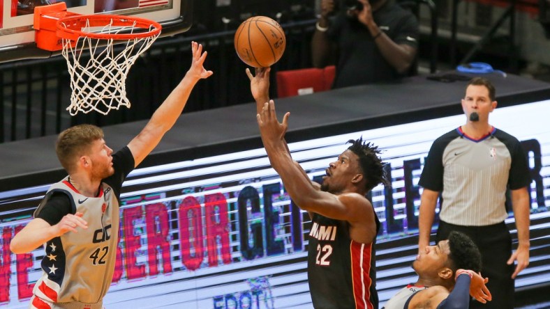 Feb 5, 2021; Miami, Florida, USA; Miami Heat forward Jimmy Butler (22) shoot a layup over Washington Wizards forward Davis Bertans (42) during the first quarter of the game at American Airlines Arena. Mandatory Credit: Sam Navarro-USA TODAY Sports