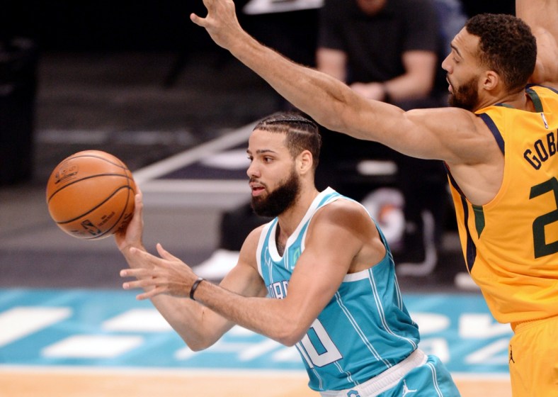 Feb 5, 2021; Charlotte, North Carolina, USA; Charlotte Hornets guard forward Caleb Martin (10) passes as he is defended by Utah Jazz center Rudy Gobert (27) during the first half at the Spectrum Center. Mandatory Credit: Sam Sharpe-USA TODAY Sports
