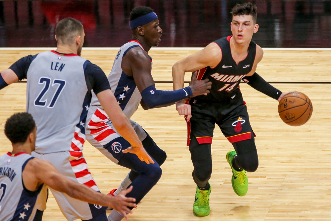 Feb 5, 2021; Miami, Florida, USA; Miami Heat guard Tyler Herro (14) dribbles the basketball around Washington Wizards forward Isaac Bonga (17) during the third quarter of the game at American Airlines Arena. Mandatory Credit: Sam Navarro-USA TODAY Sports