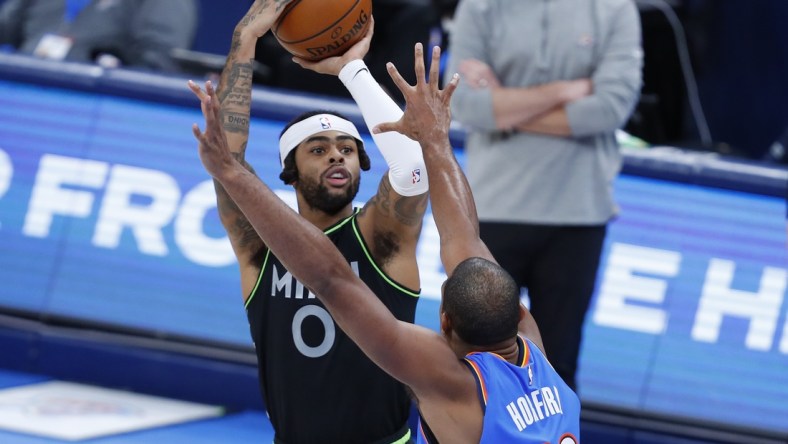 Feb 5, 2021; Oklahoma City, Oklahoma, USA; Minnesota Timberwolves guard D'Angelo Russell (0) shoots a three point basket as Oklahoma City Thunder center Al Horford (42) defends during the second half at Chesapeake Energy Arena. Minnesota won 106-103. Mandatory Credit: Alonzo Adams-USA TODAY Sports