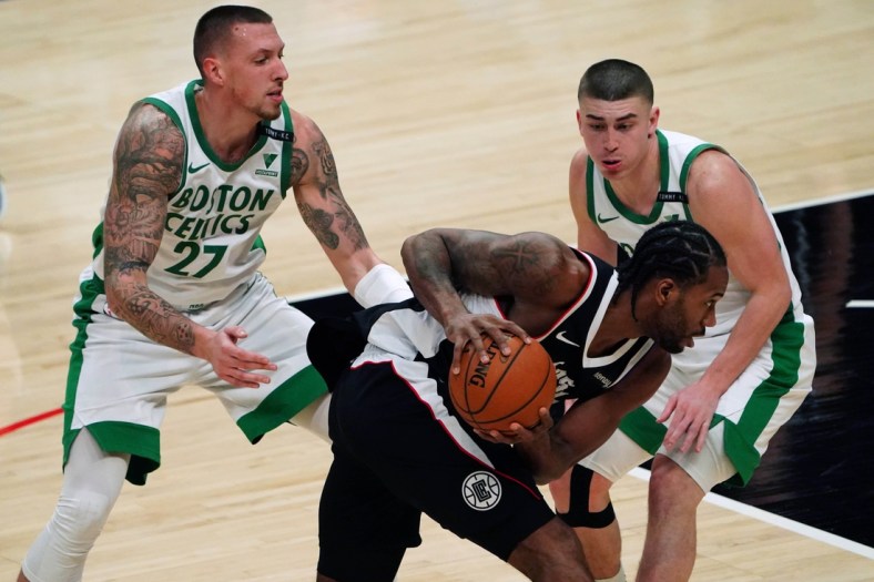 Feb 5, 2021; Los Angeles, California, USA; LA Clippers forward Kawhi Leonard (2) is defended by Boston Celtics center Daniel Theis (27) and guard Payton Pritchard (11)  in the second quarter at Staples Center. Mandatory Credit: Kirby Lee-USA TODAY Sports