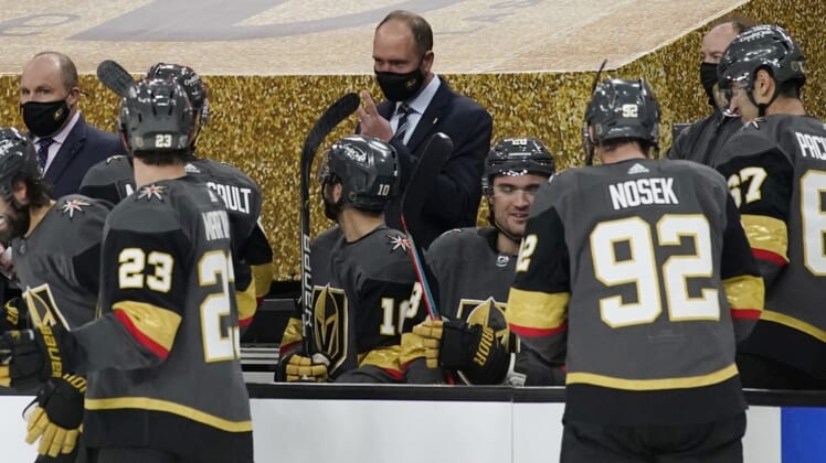 Feb 5, 2021; Las Vegas, Nevada, USA; Vegas Golden Knights head coach Peter DeBoer, center, speaks with his players during the second period of an NHL hockey game against the Los Angeles Kings, Friday, Feb. 5, 2021, in Las Vegas at T-Mobile Arena. Mandatory Credit: John Locher/Pool Photo-USA TODAY Sports
