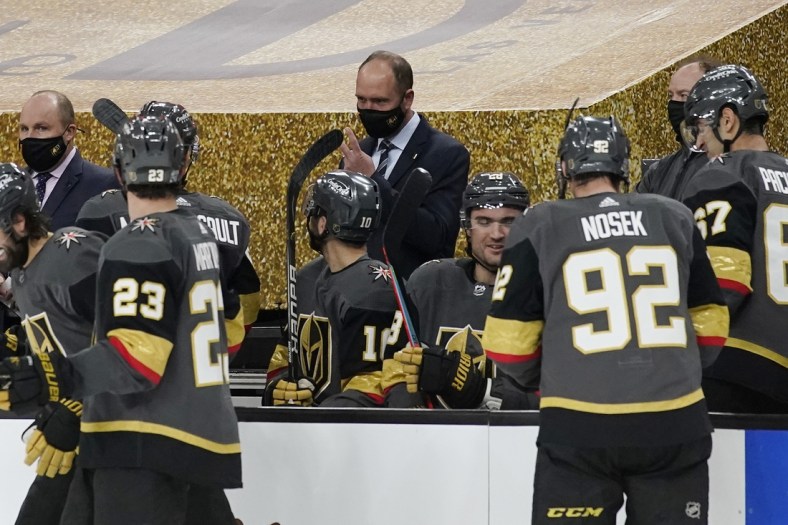 Feb 5, 2021; Las Vegas, Nevada, USA; Vegas Golden Knights head coach Peter DeBoer, center, speaks with his players during the second period of an NHL hockey game against the Los Angeles Kings, Friday, Feb. 5, 2021, in Las Vegas at T-Mobile Arena. Mandatory Credit: John Locher/Pool Photo-USA TODAY Sports