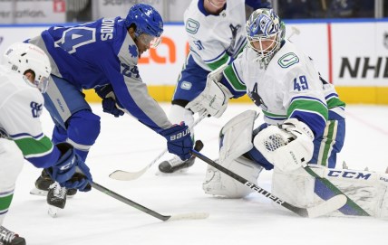 Feb 6, 2021; Toronto, Ontario, CAN; Vancouver Canucks goalie Braden Holtby (49) makes a save against Toronto Maple Leafs forward Wayne Simmonds (24) in the first period at Scotiabank Arena. Mandatory Credit: Dan Hamilton-USA TODAY Sports