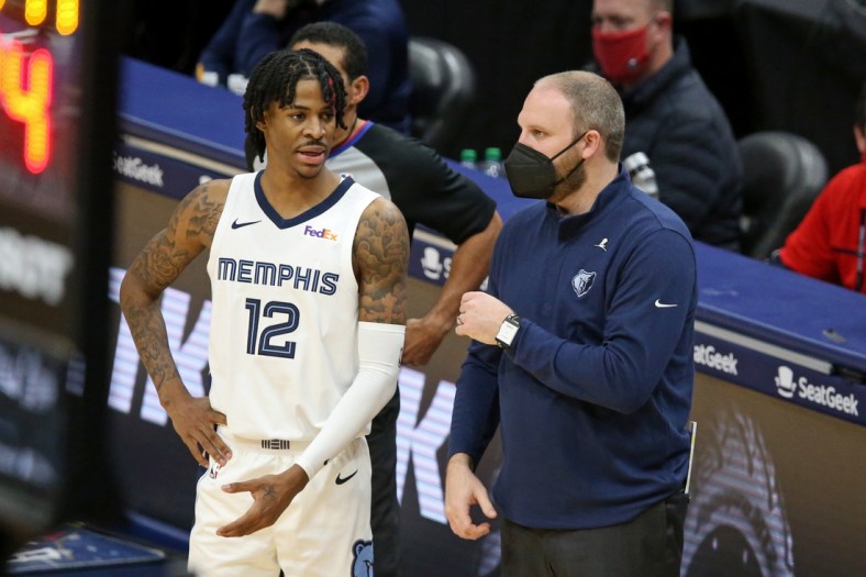 Feb 6, 2021; New Orleans, Louisiana, USA; Memphis Grizzlies guard Ja Morant (12) talks to Memphis Grizzlies head coach Taylor Jenkins (R) in the third quarter against the New Orleans Pelicans at the Smoothie King Center. Mandatory Credit: Chuck Cook-USA TODAY Sports