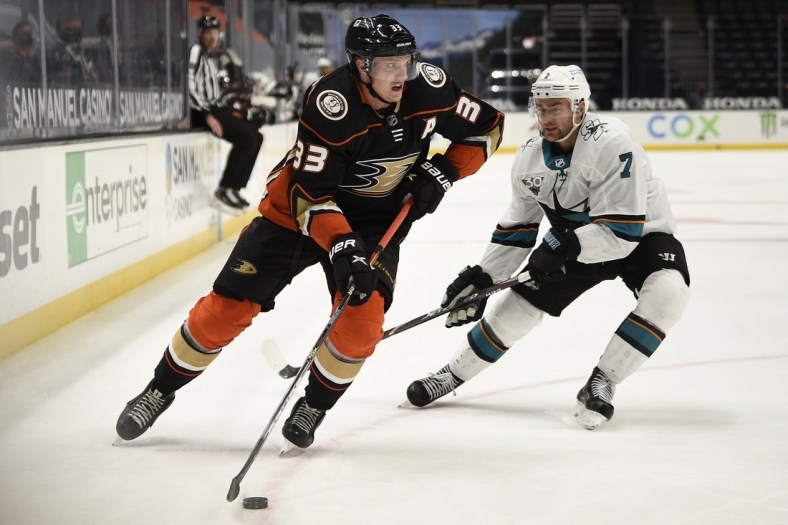 Feb 6, 2021; Anaheim, California, USA; Anaheim Ducks right wing Jakob Silfverberg (33) moves the puck around San Jose Sharks center Dylan Gambrell (7) during the second period at Honda Center. Mandatory Credit: Kelvin Kuo-USA TODAY Sports