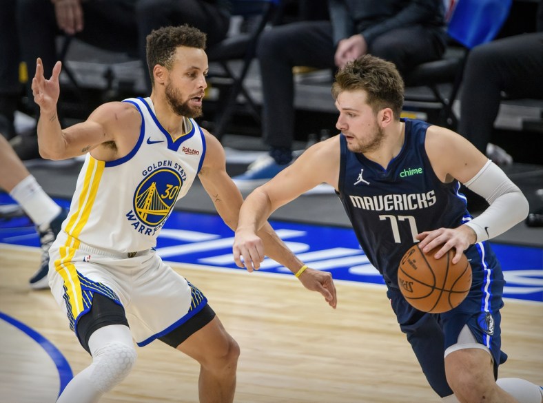 Feb 6, 2021; Dallas, Texas, USA; Golden State Warriors guard Stephen Curry (30) guards Dallas Mavericks guard Luka Doncic (77) during the second half at the American Airlines Center. Mandatory Credit: Jerome Miron-USA TODAY Sports