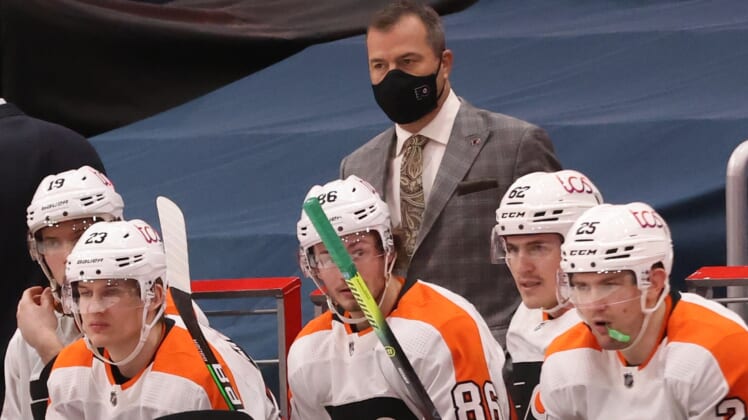 Feb 7, 2021; Washington, District of Columbia, USA; Philadelphia Flyers head coach Alain Vigneault (M) looks on from behind the bench against the Washington Capitals in the third period at Capital One Arena. Mandatory Credit: Geoff Burke-USA TODAY Sports
