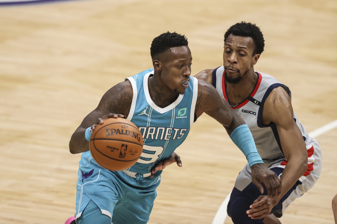 Feb 7, 2021; Charlotte, North Carolina, USA; Charlotte Hornets guard Terry Rozier (3) drives around Washington Wizards guard Ish Smith in the second half at Spectrum Center. The Charlotte Hornets won 119-97. Mandatory Credit: Nell Redmond-USA TODAY Sports