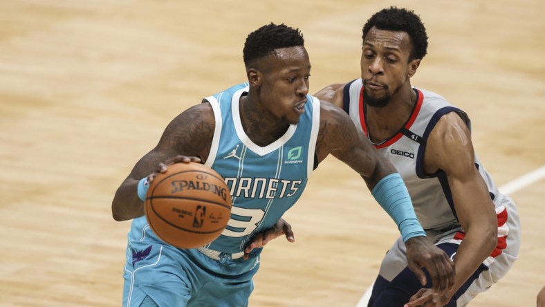 Feb 7, 2021; Charlotte, North Carolina, USA; Charlotte Hornets guard Terry Rozier (3) drives around Washington Wizards guard Ish Smith in the second half at Spectrum Center. The Charlotte Hornets won 119-97. Mandatory Credit: Nell Redmond-USA TODAY Sports