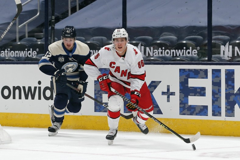 Feb 7, 2021; Columbus, Ohio, USA; Carolina Hurricanes left wing Teuvo Teravainen (86) carries the puck as Columbus Blue Jackets center Alexandre Texier (42) trails the play during the first period at Nationwide Arena. Mandatory Credit: Russell LaBounty-USA TODAY Sports