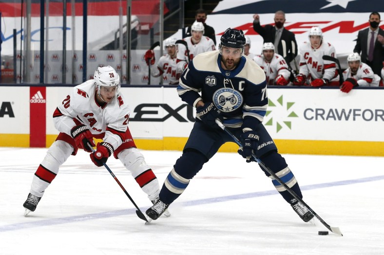 Feb 7, 2021; Columbus, Ohio, USA; Columbus Blue Jackets left wing Nick Foligno (71) looks to pass as Carolina Hurricanes right wing Sebastian Aho (20) pursues during the third period at Nationwide Arena. Mandatory Credit: Russell LaBounty-USA TODAY Sports