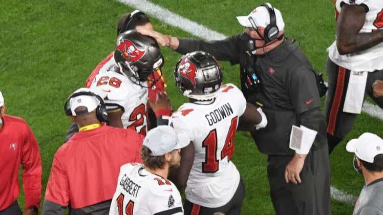 Feb 7, 2021; Tampa, FL, USA; Tampa Bay Buccaneers running back Leonard Fournette (28) is congratulated by head coach Bruce Arians (right) after a touchdown run in the third quarter of Super Bowl LV at Raymond James Stadium.  Mandatory Credit: James Lang-USA TODAY Sports