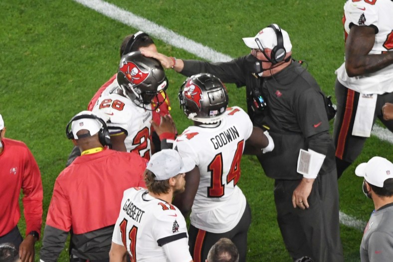 Feb 7, 2021; Tampa, FL, USA; Tampa Bay Buccaneers running back Leonard Fournette (28) is congratulated by head coach Bruce Arians (right) after a touchdown run in the third quarter of Super Bowl LV at Raymond James Stadium.  Mandatory Credit: James Lang-USA TODAY Sports