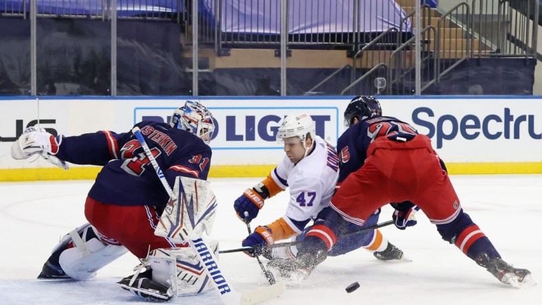 Feb 8, 2021; New York, NY, USA;  Igor Shesterkin #31 and Libor Hajek #25 of the New York Rangers combine to stop Leo Komarov #47 of the New York Islanders during the first period at Madison Square Garden on February 08, 2021 in New York City.  Mandatory Credit: Bruce Bennett/Pool Photo-USA TODAY Sports