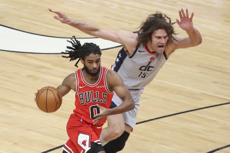 Feb 8, 2021; Chicago, Illinois, USA; Chicago Bulls guard Coby White (0) is defended by Washington Wizards center Robin Lopez (15) during the first half of an NBA game at United Center. Mandatory Credit: Kamil Krzaczynski-USA TODAY Sports