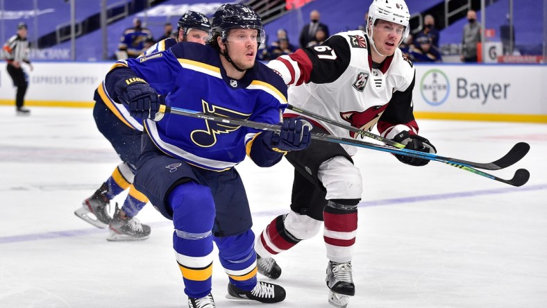 Feb 8, 2021; St. Louis, Missouri, USA;  St. Louis Blues left wing Jacob De La Rose (61) skates against Arizona Coyotes left wing Lawson Crouse (67) during the first period at Enterprise Center. Mandatory Credit: Jeff Curry-USA TODAY Sports