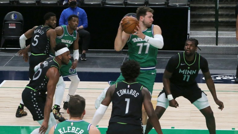 Feb 8, 2021; Dallas, Texas, USA; Dallas Mavericks guard Luka Doncic (77) looks to pass as Minnesota Timberwolves center Naz Reid (11) defends during the first half at American Airlines Center. Mandatory Credit: Kevin Jairaj-USA TODAY Sports