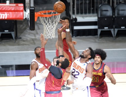 Feb 8, 2021; Phoenix, Arizona, USA; Phoenix Suns center Deandre Ayton (22) blocks away a layup attempt by Cleveland Cavaliers center Andre Drummond (3) during the first half at Phoenix Suns Arena. Mandatory Credit: Joe Camporeale-USA TODAY Sports