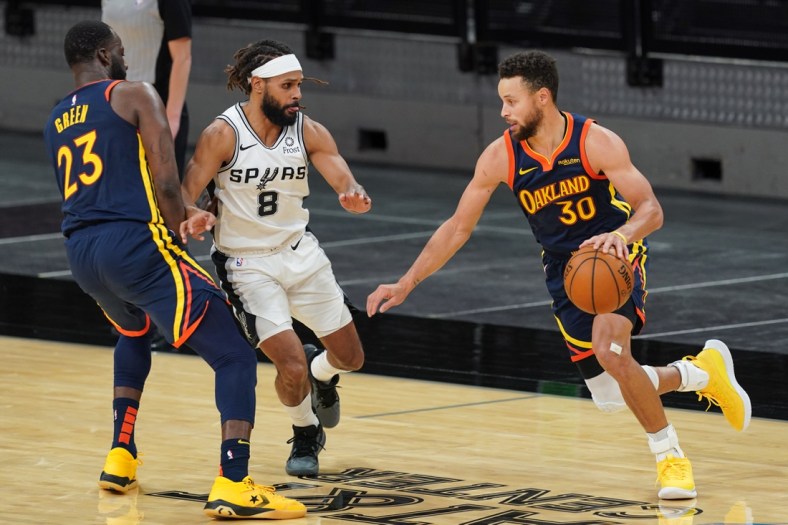 Feb 8, 2021; San Antonio, Texas, USA;  Golden State Warriors guard Stephen Curry (30) dribbles around San Antonio Spurs guard Patty Mills (8) in the first half at the AT&T Center. Mandatory Credit: Daniel Dunn-USA TODAY Sports